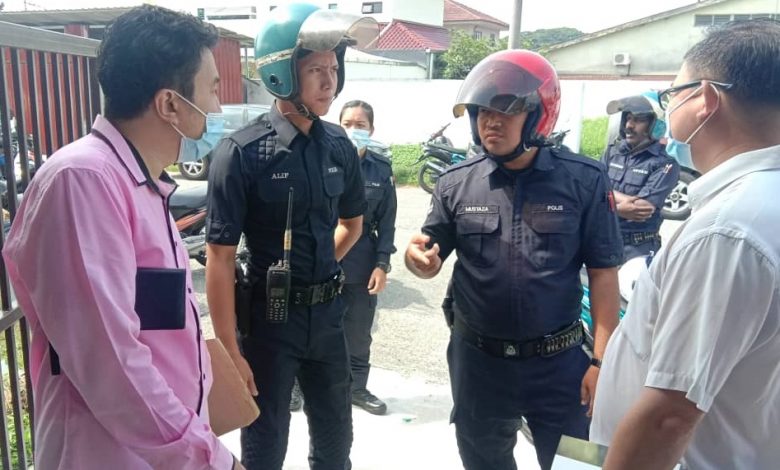 警員在講座會進行途中到場；蔡鎮菖（左）和張志堅（右）與警員交涉後，講座會繼續進行。