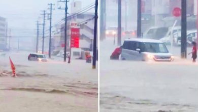 Photo of 沖繩降雨量破紀錄 水深及大腿 民眾涉水推車