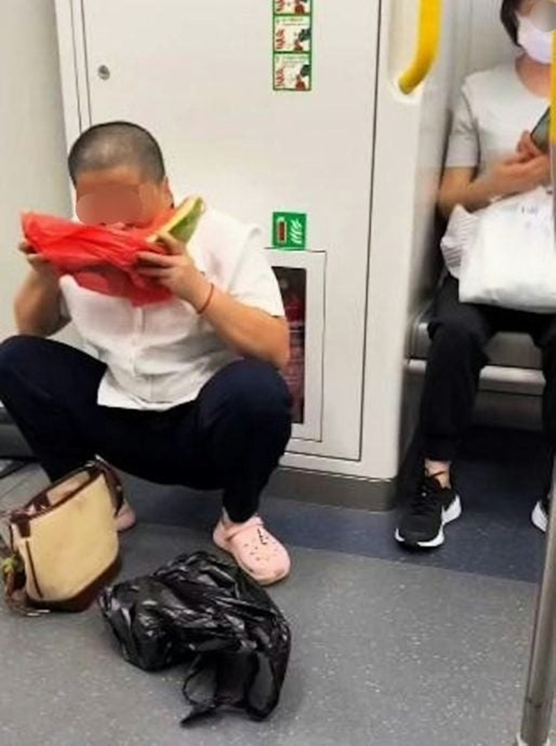 大叔在乘搭地铁期间，竟蹲在车厢内大口啃食经已切开的西瓜